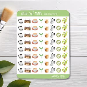 May include: A sticker sheet with hand-illustrated cafe-themed designs. The sheet features images of coffee pots, cafe signs, coffee cups, espresso makers, latte art, and potted plants. The text "GREEN CAFÉ MINIS HAND ILLUSTRATED" is at the top.