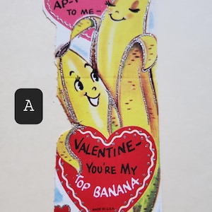 May include: Vintage Valentine's Day card featuring two cartoon bananas with hearts and the text "You AP-PEAL TO ME- VALENTINE- YOU'RE MY TOP BANANA".
