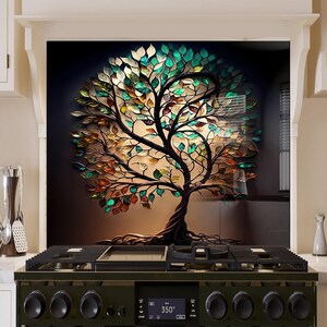 May include: A colorful glass mosaic tree with brown branches and roots against a dark background. The tree is made of many small pieces of glass in shades of green, blue, yellow, and orange. The tree is a decorative piece for a kitchen or home.