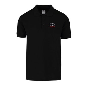 May include: Black polo shirt with a white Toyota logo and the word "TOYOTA" in red lettering.