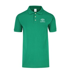 May include: A green polo shirt with a white Toyota logo and the word "TOYOTA" embroidered on the chest.