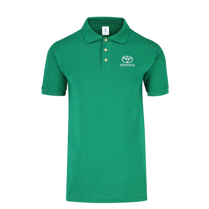 May include: A green polo shirt with a white Toyota logo and the word "TOYOTA" embroidered on the chest.