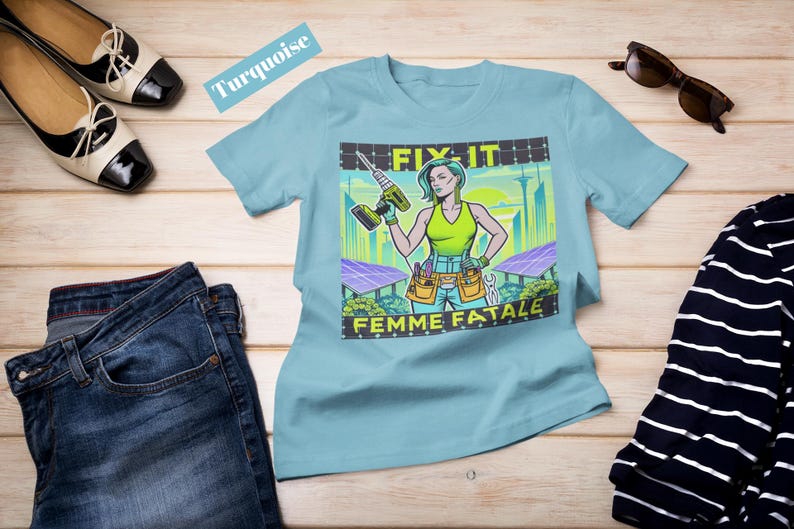 May include: A turquoise t-shirt featuring a graphic of a woman with a drill, the text "FIX IT" and "FEMME FATALE". The image also includes a pair of blue jeans, black and white shoes, sunglasses, and a striped shirt.