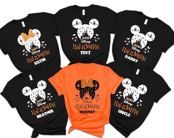 May include: Black and orange Halloween t-shirts with a Disney theme. Each shirt features a Mickey Mouse head silhouette with a castle, bats, and the text "Halloween" and a family member's title, such as "Sister" or "Mommy."