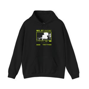 May include: Black hoodie with a graphic print of a white image with the text "MX.37 CULTURE" and "MX. THIRTY SEVEN" in a yellow box. The text "THEY/THEM" is printed below the box.
