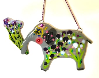 Baby elephant with a heart on it's cheek delivering joyful bunch of purple flowers fused glass wall hanging