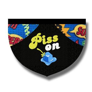May include: Black patch with the words "Piss on" in yellow and white, with a blue and yellow cartoon graphic. The background features comic book style text bubbles and patterns.