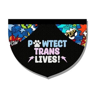 May include: A black pet bandana with the text "P*WTECT TRANS LIVES!" in white, light blue, and pink. The bandana has a comic book style border with "WOW" and "POP" text bubbles.