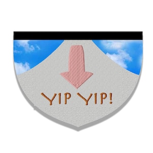 May include: A light gray, shield-shaped patch with a pink arrow pointing down. The patch has the text "YIP YIP!" in a brown, stylized font. The top of the patch is black, and the background is a blue sky with clouds.