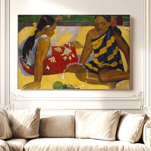 May include: Two women sit on a yellow patterned surface. The woman on the left wears a red and white patterned dress and a yellow headband. The woman on the right wears a blue and yellow striped dress. The painting is done in a style reminiscent of Paul Gauguin.