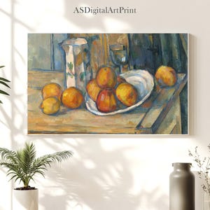 May include: A framed print of a still life painting featuring a white pitcher with floral designs, a glass, and a white plate filled with oranges and peaches. The painting is on a wooden table.
