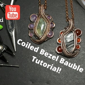 May include: Two wire wrapped pendants with coiled bezels. The pendant on the left has a green stone with purple stones around it. The pendant on the right has a gray stone with orange stones around it. The text "Coiled Bezel Bauble Tutorial!" is written below the pendants.