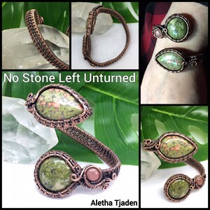 Puede incluir: Pulsera de alambre de cobre envuelta con dos piedras verdes y marrones y una piedra rosa. La pulsera es de estilo brazalete y est&aacute; abierta por un lado. El texto "No Stone Left Unturned" y "Aletha Tjaden" son visibles en la imagen.