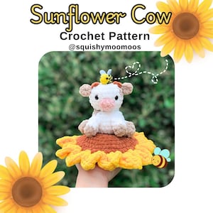 May include: A crocheted sunflower with a crocheted cow sitting on top. The cow is white with brown spots and has a bee on its head. The sunflower is yellow with brown petals. The text "Sunflower Cow Crochet Pattern @squishymoomoos" is written above the image.