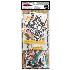 May include: A clear plastic package containing paper ephemera. The ephemera includes die-cut shapes with floral, butterfly, and script designs. Text includes "fierce, brave and strong" and "happiness". The package also has the text "Vicki Boutin".