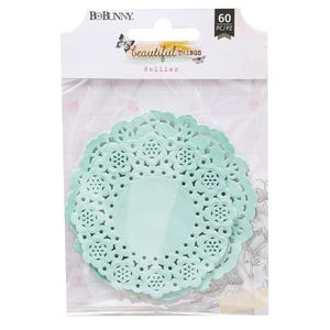 May include: A package of 60 light blue paper doilies with a delicate lace pattern. The package is labeled "Beautiful Things Doilies" by BoBunny.