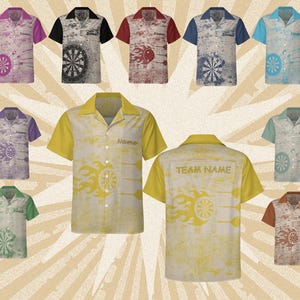 May include: Collection of short-sleeved button-down shirts with dartboard and flame designs. Shirts feature various color combinations, including yellow, blue, red, and green. Some shirts have "Name" and "Team Name" printed on them.