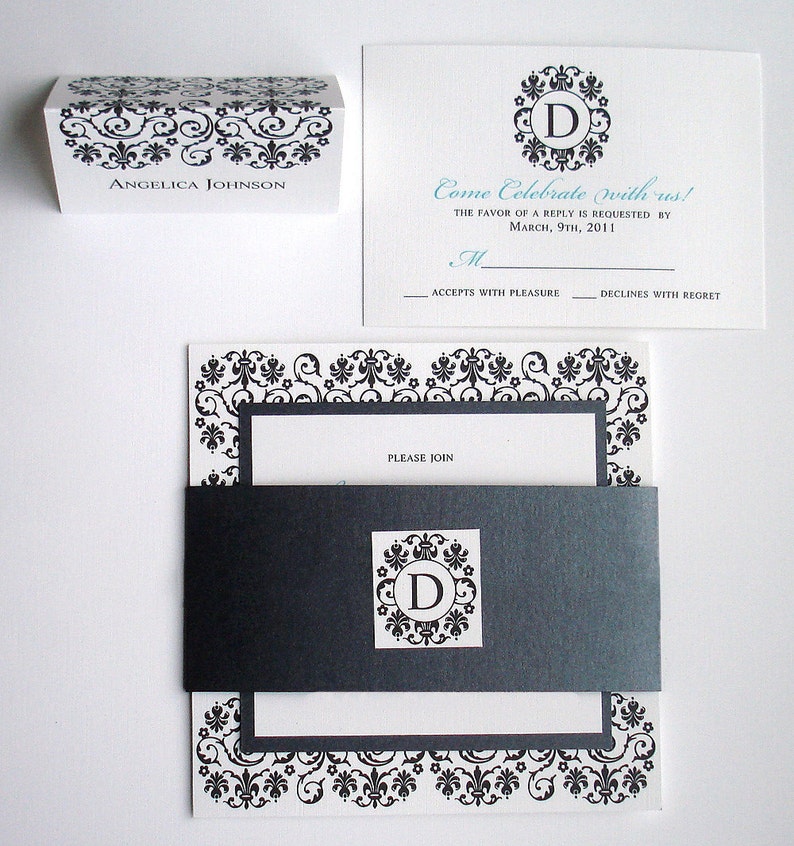 May include: Black and white wedding invitation with a decorative border. The invitation features a monogram with the letter "D" in a circle. The text reads "Come Celebrate with us! The favor of a reply is requested by March, 9th, 2011. M. Accepts with pleasure. Declines with regret. Please join."