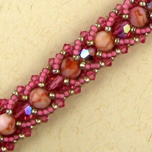 Peut inclure: Un bracelet en perles rose et argent avec des perles à motifs rouge et blanc.
