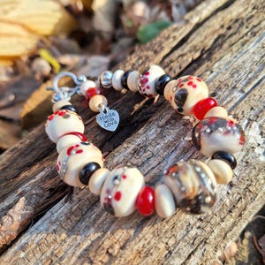 lvory, red, and black with silver dots bracelet