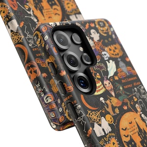 May include: A black smartphone case featuring a repeating Halloween pattern with orange pumpkins, white ghosts, skeletons, spiderwebs, bats, and candy. The text "Halloween never dies" and "This is my haunted hotspot" is printed on the case surface.