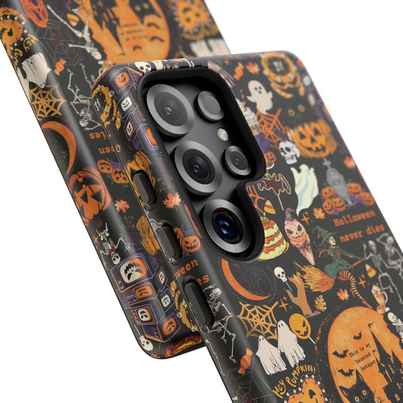 May include: A black smartphone case featuring a repeating Halloween pattern with orange pumpkins, white ghosts, skeletons, spiderwebs, bats, and candy. The text "Halloween never dies" and "This is my haunted hotspot" is printed on the case surface.