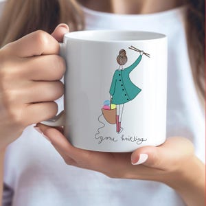 May include: White ceramic mug with a cartoon illustration of a woman holding knitting needles and a basket of yarn. The text "gone knitting" is written below the illustration.