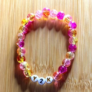 Pulsera con letras y cuentas de vidrio en rosa y amarillo con temática Y2K