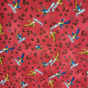 May include: Red fabric with a repeating pattern of blue and yellow birds carrying banners with coffee-themed text. The banners say "Coffee & Scones", "Sweet Treats", "Tumblers", "Delicious", "Burritos", and "Fresh Fruit". The background is covered in brown coffee beans.