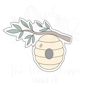 May include: A cookie cutter in the shape of a beehive with a branch and leaves. The beehive has a small bee inside and a round opening.