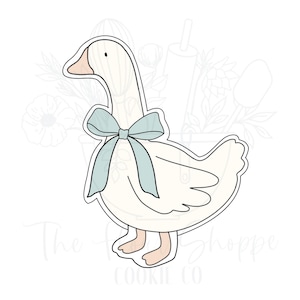 May include: A white goose cookie cutter with a blue bow. The goose is standing with its wings spread out and its head turned to the side. The cookie cutter is perfect for making cute goose-shaped cookies.