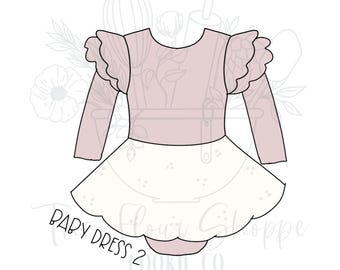 May include: A pink and white baby dress with long sleeves and a ruffled neckline. The dress has a white skirt with a scalloped hem and the text "Baby Dress 2" is printed on the bottom.