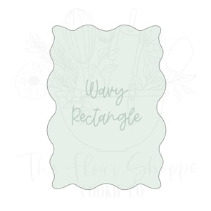 May include: A light green cookie cutter in the shape of a wavy rectangle. The text "Wavy Rectangle" is written in cursive in the center of the cutter. The Flour Shoppe Cookie Co. is written at the bottom.