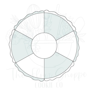 May include: A white cookie cutter in the shape of a segmented circle with a scalloped edge. The center is a smaller circle. The text "The Flory Shoppe COOKIE CO" is at the bottom.