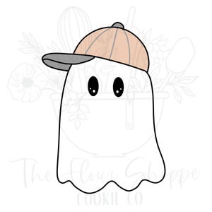 May include: A white ghost-shaped cookie cutter wearing a tan and gray baseball cap. The ghost has two large black oval eyes. The Flour Shoppe Cookie Co. logo is at the bottom.