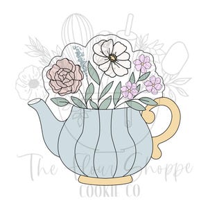 May include: A light blue teapot cookie cutter with a bouquet of flowers. The flowers include a pink rose, white flower, and small purple flowers. The handle and base of the teapot are yellow. The text "The Flour Shoppe Cookie Co" is at the bottom.