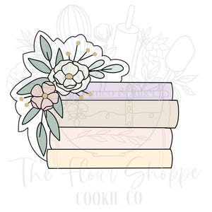 May include: A stack of five books with a floral design on top. The books are in shades of purple, beige, and pink. The floral design is in shades of green, pink, and white.