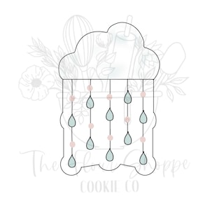 May include: A cloud-shaped cookie cutter with hanging teardrop shapes and small round beads. The cutter has a scalloped bottom edge and the text "The Flour Shoppe Cookie Co" is printed on the bottom.