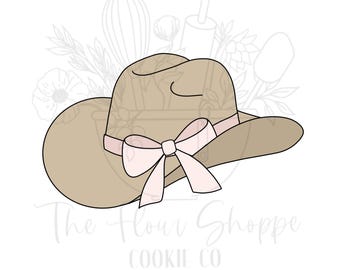 May include: A tan cowboy hat with a pink ribbon bow. The hat is a cookie cutter design, with the text "The Flour Shoppe Cookie Co" at the bottom. The background features faint floral and kitchen utensil illustrations.