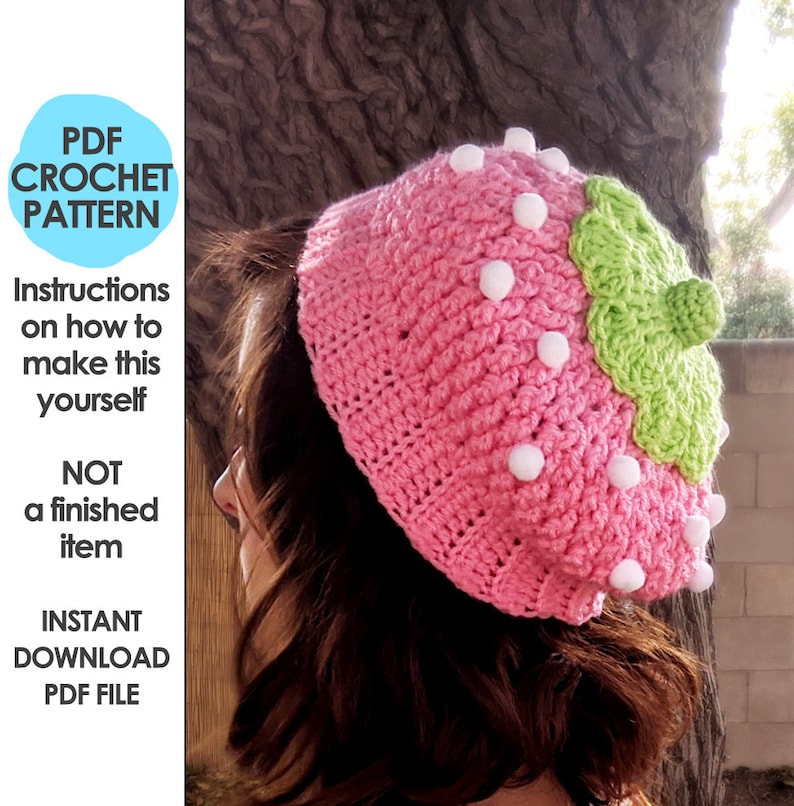 May include: A pink and green crochet hat shaped like a strawberry. The hat has white pom-poms around the edge and a green leaf on top. The hat is a crochet pattern, not a finished item.  PDF download.