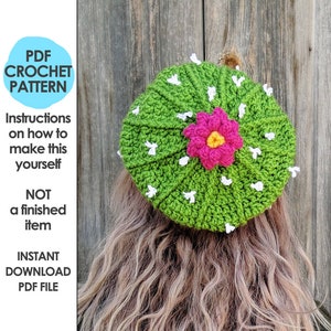 May include: A crochet pattern for a green cactus hat with a pink flower and white accents. The pattern is available as an instant download PDF file.