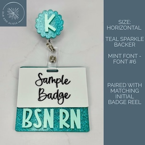 May include: A teal glitter badge reel featuring a scalloped circular topper with the letter K in mint green. Attached is a rectangular badge holder with a white top section displaying the black text Sample Badge and a teal glitter bottom with BSN RN.