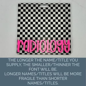 May include: A square badge reel featuring a black and white checkered pattern with the word radiology in bright pink, raised, cursive lettering. The top center of the badge has a horizontal slot for attachment, providing a clear, high-contrast design.