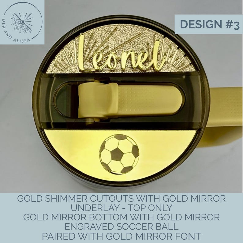 May include: A circular tumbler lid featuring a gold shimmer top section with the name Leonel in gold script and a gold mirror bottom section with an engraved football graphic. The lid includes a central sliding closure mechanism in light gold.