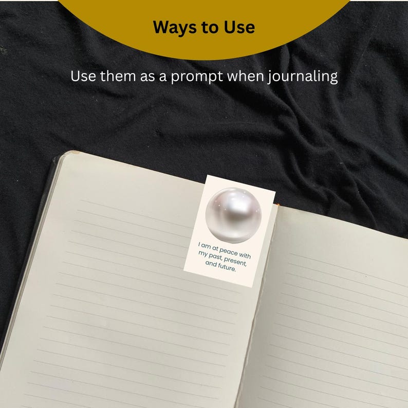 May include: Open notebook with lined pages, featuring a small card with a pearl graphic and the text "I am at peace with my past, present, and future." The image also includes the text "Ways to Use" and "Use them as a prompt when journaling."