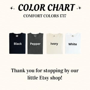 May include: Color chart featuring four t-shirts in black, pepper, ivory, and white. The text "COLOR CHART" and "COMFORT COLORS 1717" are at the top. The text "Black", "Pepper", "Ivory", and "White" are written on each shirt. The bottom text says "Thank you for stopping by our little Etsy shop!"