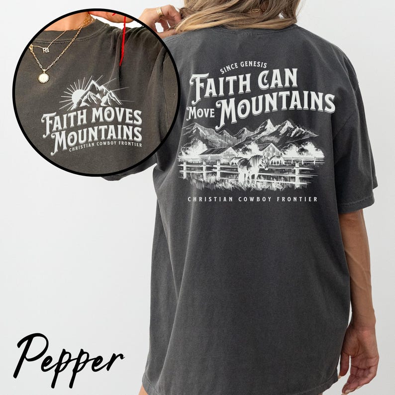 May include: Pepper-colored t-shirt with white text and graphic. The front features "Faith Moves Mountains" with a mountain and sun design. The back displays "Faith Can Move Mountains" with a mountain and horse scene. "Christian Cowboy Frontier" is printed on both sides.