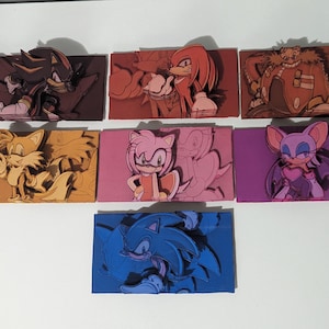 May include: Seven colorful wooden panels featuring different characters from the Sonic the Hedgehog video game franchise. The characters are Shadow the Hedgehog, Tails, Amy Rose, Rouge the Bat, Knuckles the Echidna, and Sonic the Hedgehog.