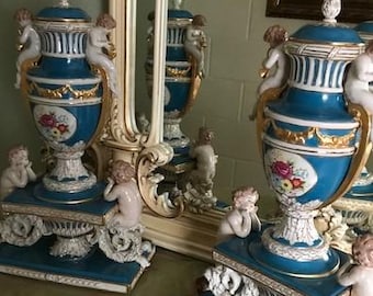 large German porcelain vases in the French Sevres style with cherubs and griffins