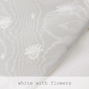 white moire fabric with small jacquard flowers